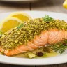 Pistachio salmon served with roasted asparagus and quinoa on a plate.